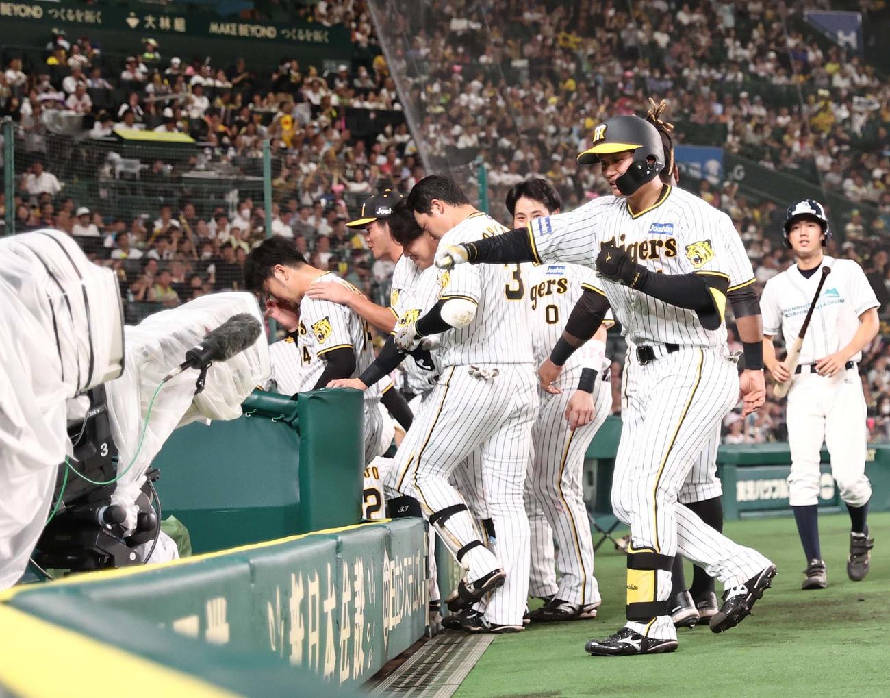 阪神対ヤクルト　8回裏阪神無死、プロ1号本塁打を放った森下はベンチ前でポーズを決める（撮影・上田博志）