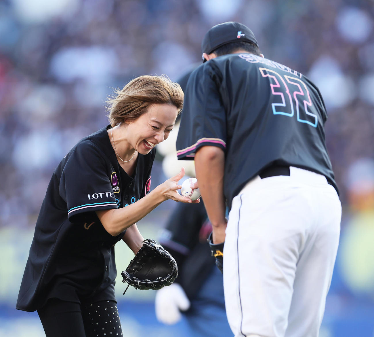 ロッテ対楽天　セレモニアルピッチを行った鈴木亜美（左）はロッテ佐藤都からボールを受け取る（撮影・足立雅史）