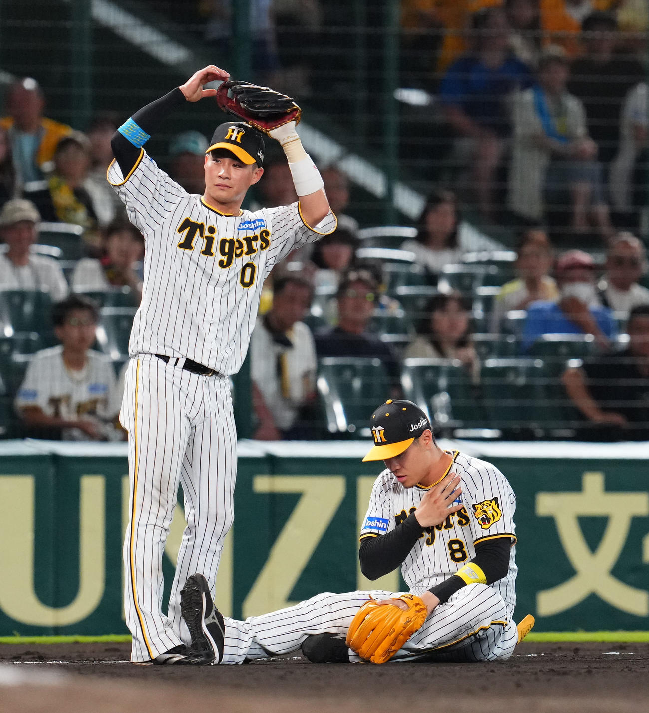 阪神対中日　7回表中日無死、代打福永の打球を左鎖骨付近に受けた阪神三塁手佐藤輝（右）（撮影・藤尾明華）