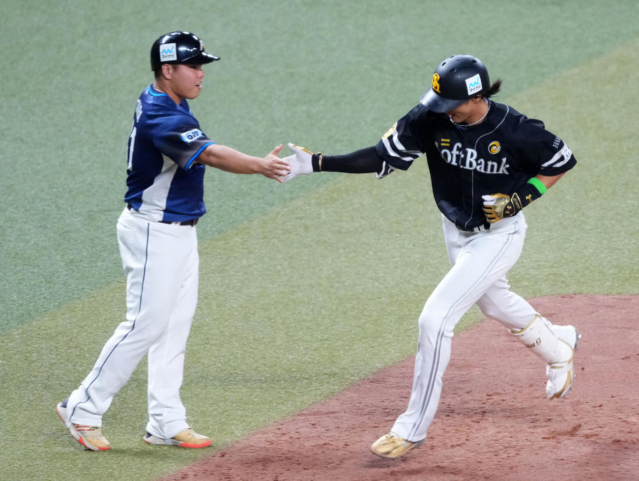 全セ対全パ　3回表全パ1死、右越えソロ本塁打を放ち平良（左）とタッチを交わす柳田（撮影・横山健太）