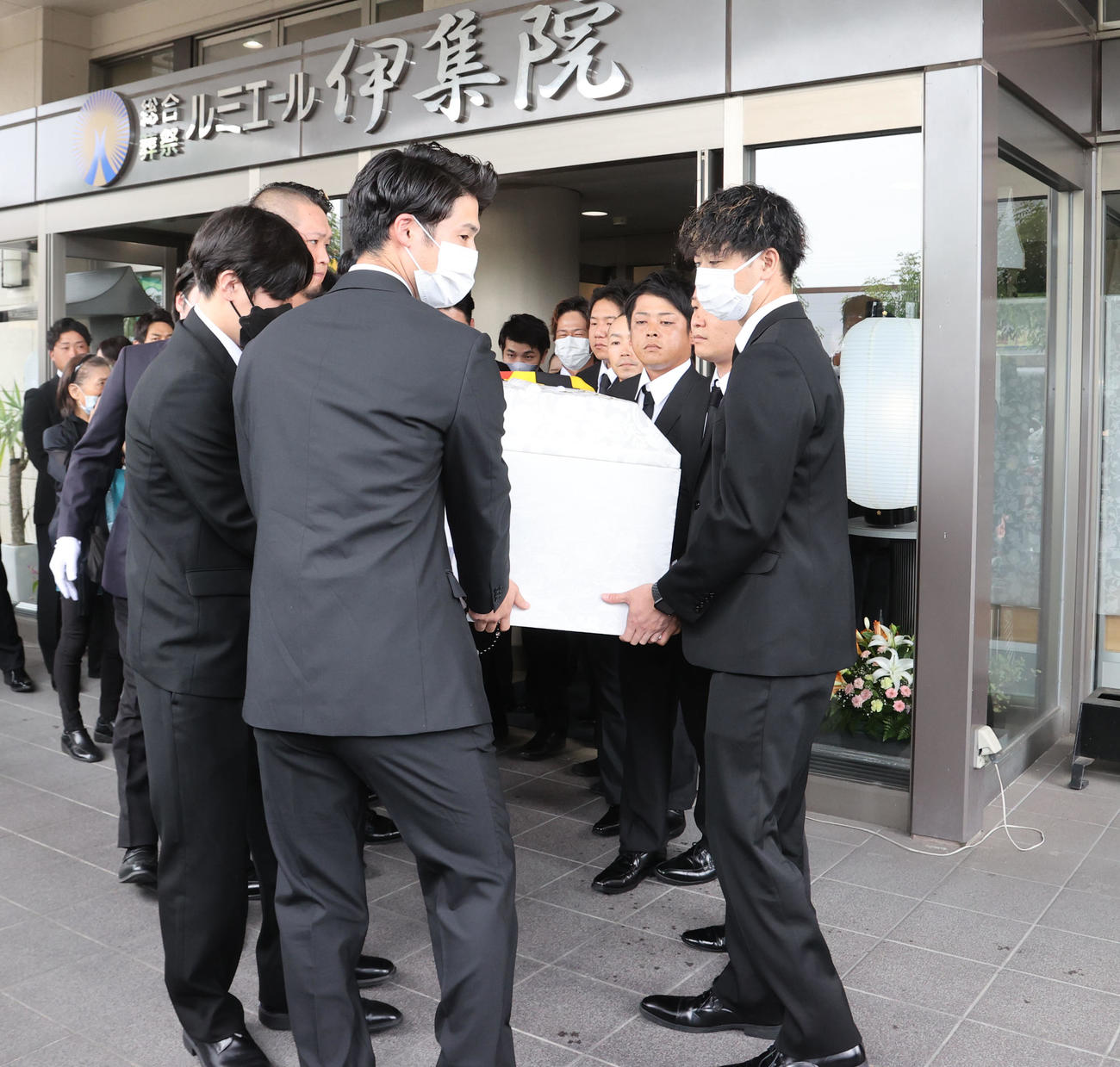 親しい友人らに支えられ葬儀場を出る故・横田氏（撮影・梅根麻紀）