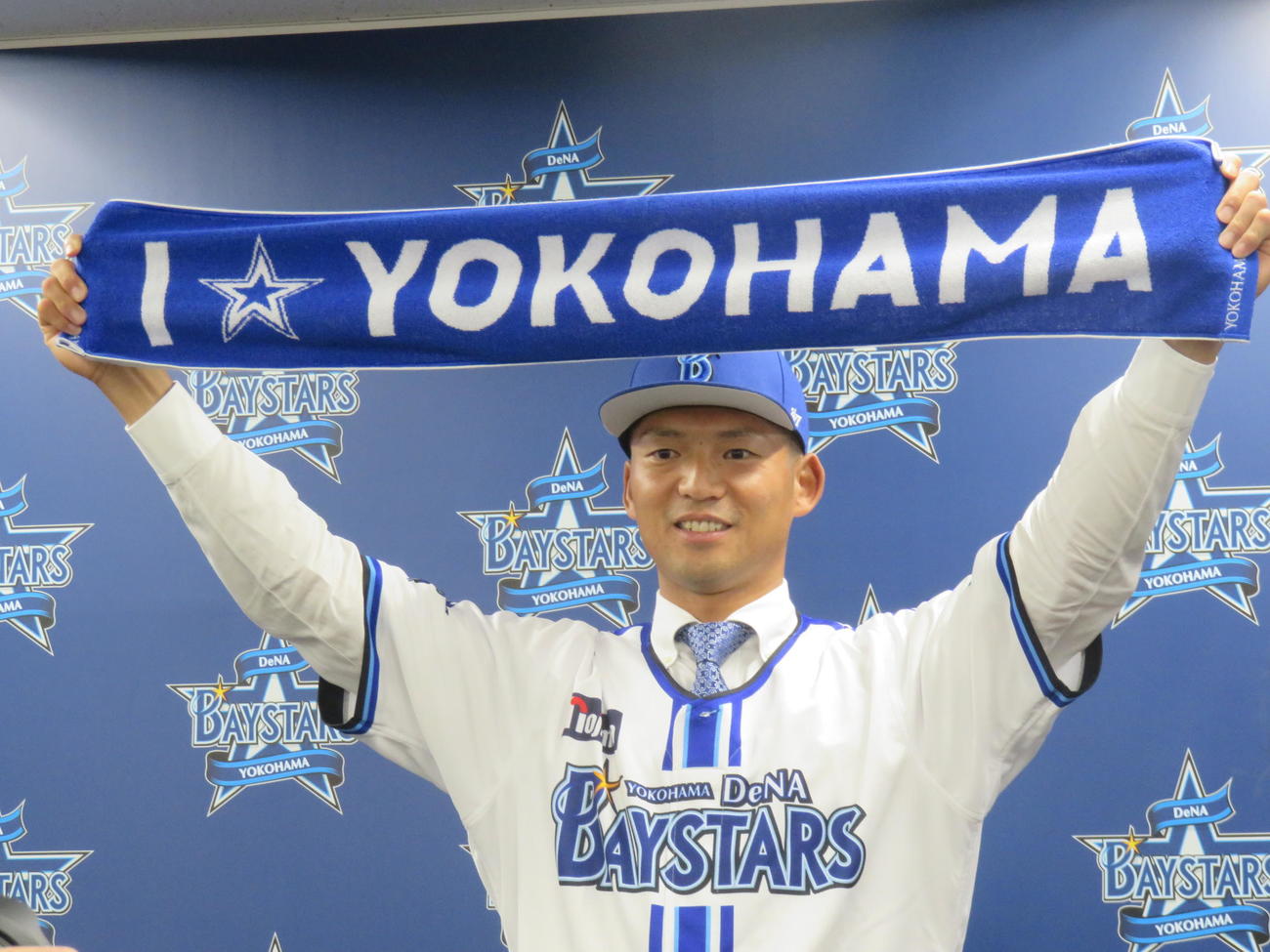 入団会見を行ったDeNA西浦は、ベイスターズのタオルを掲げる