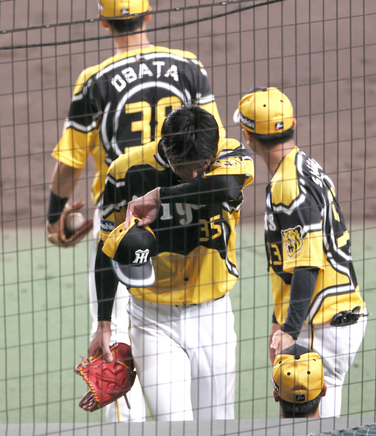 阪神対巨人　5回表巨人2死二塁、才木（手前）は途中降板し、うつむきながらベンチへ引き揚げる（撮影・上山淳一）