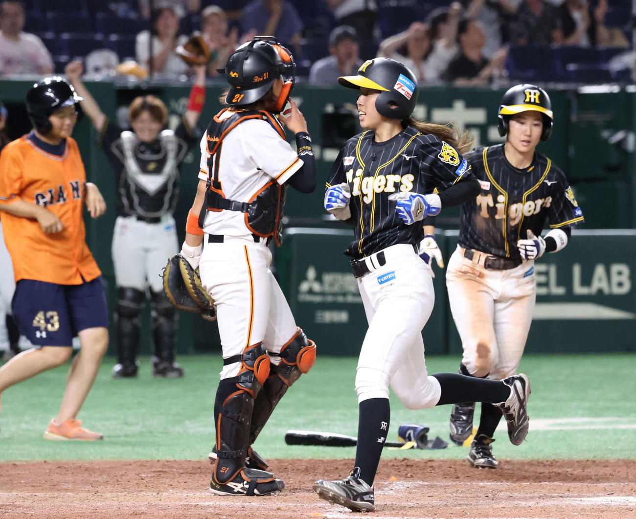 女子野球交流戦　巨人対阪神　6回表阪神1死満塁、中江（右）が四球を選んで三塁走者東尾（中央）が生還して追いつく。捕手金満（撮影・丹羽敏通）