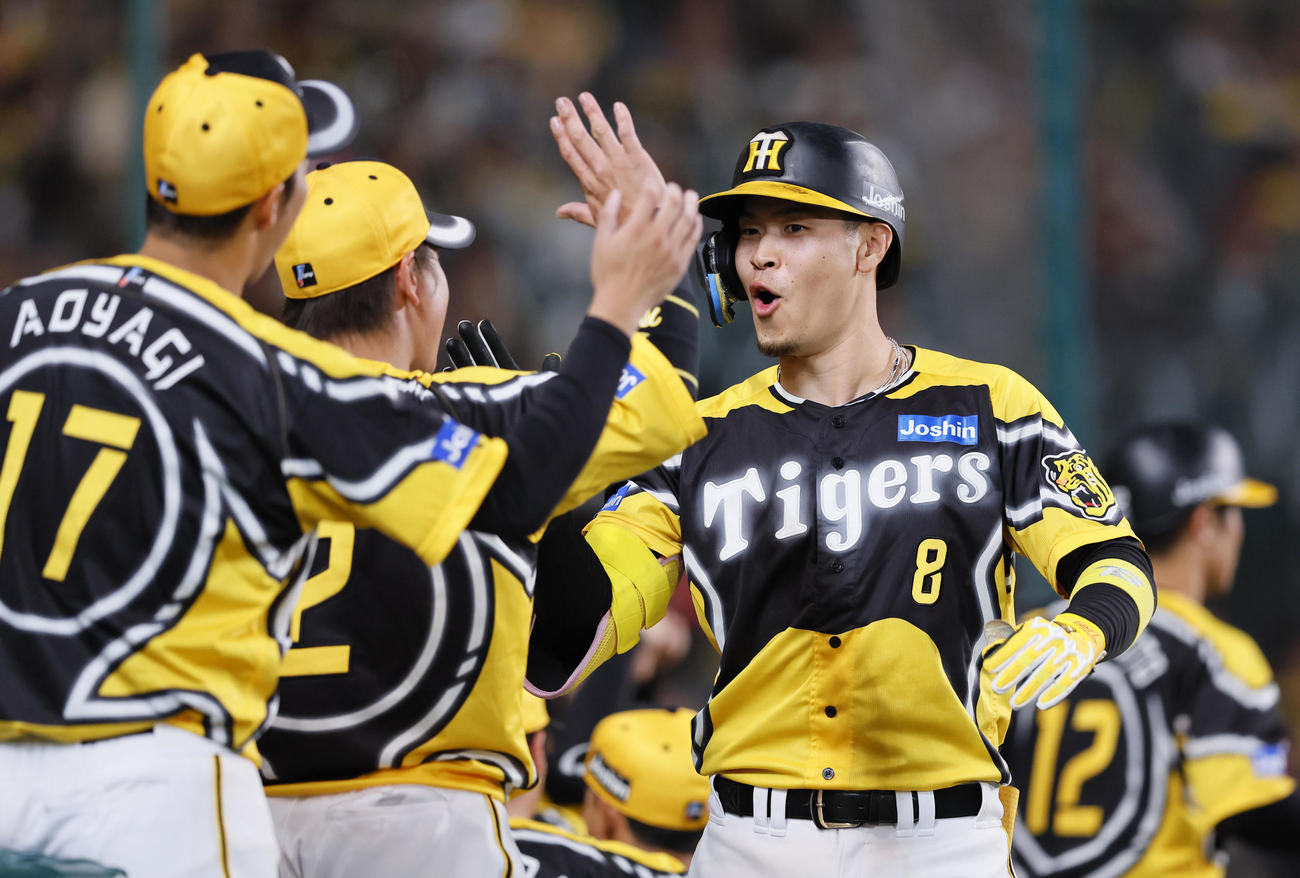 阪神対広島　6回裏阪神1死、右中間に勝ち越しの本塁打を放ちタッチを交わす佐藤輝（撮影・藤尾明華）