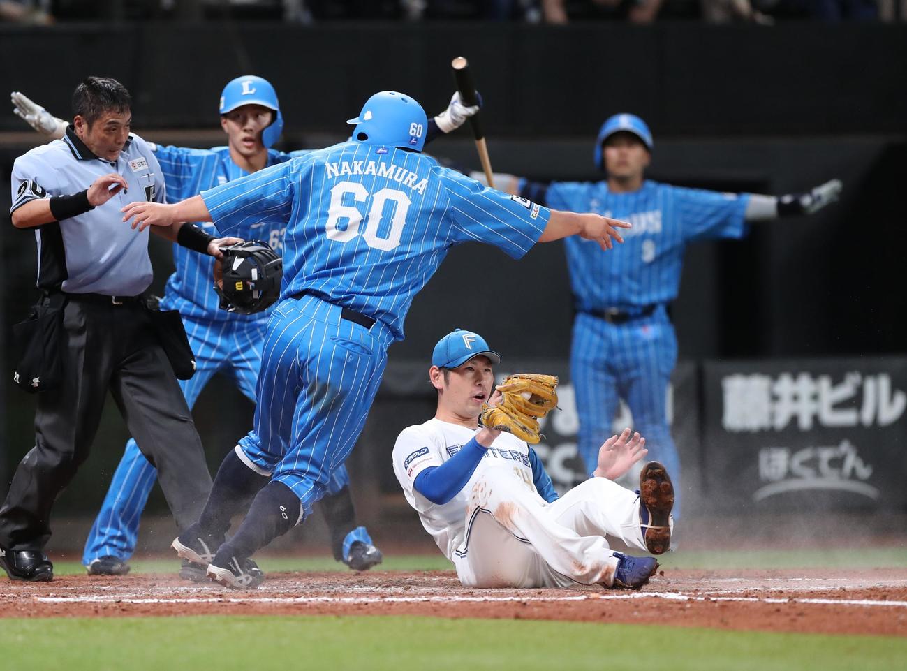 日本ハム対西武　4回表西武2死三塁、暴投で本塁ベースカバーに入った加藤貴（手前右）だが間に合わず中村（同中央）の生還を許す（撮影・黒川智章）