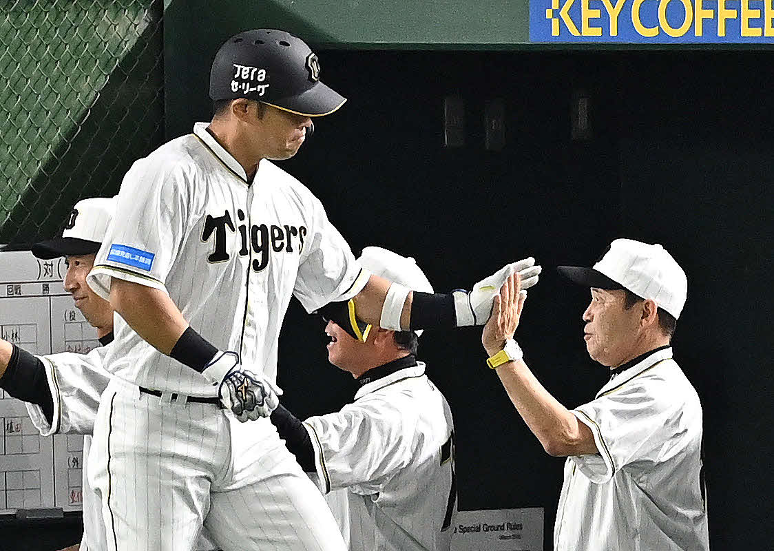 巨人対阪神　9回表阪神1死一塁、岡田監督（右）は2点本塁打を放った代打の代打原口とタッチをかわす（撮影・滝沢徹郎）