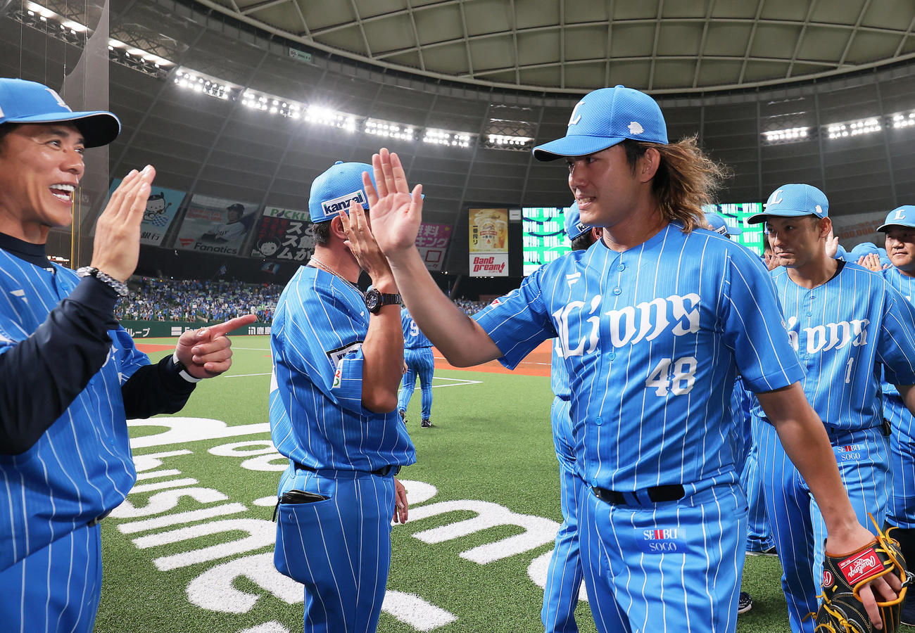 西武対楽天　1失点完投勝利の西武今井（右）は松井監督とタッチを交わす（撮影・足立雅史）