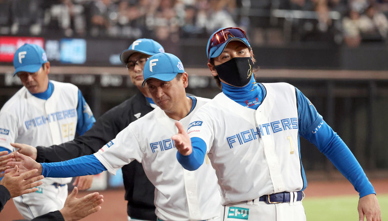 日本ハム対ロッテ　ロッテに勝利しコーチ陣とタッチをする新庄監督（右）（撮影・佐藤翔太）