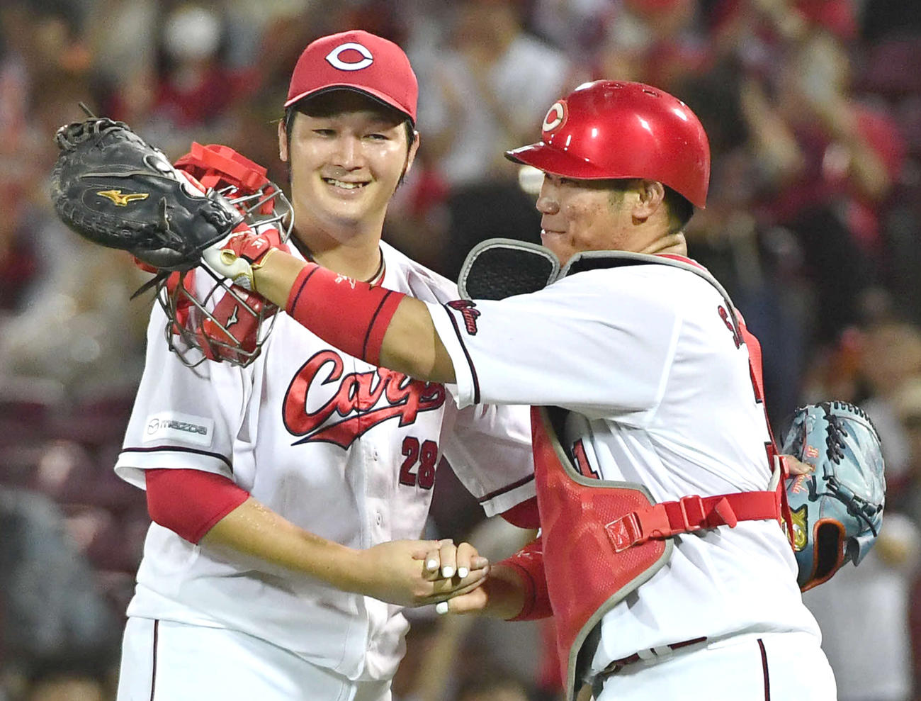 広島対阪神　完封で10勝目を挙げ、坂倉（右）と笑顔で握手を交わす床田（撮影・岩下翔太）