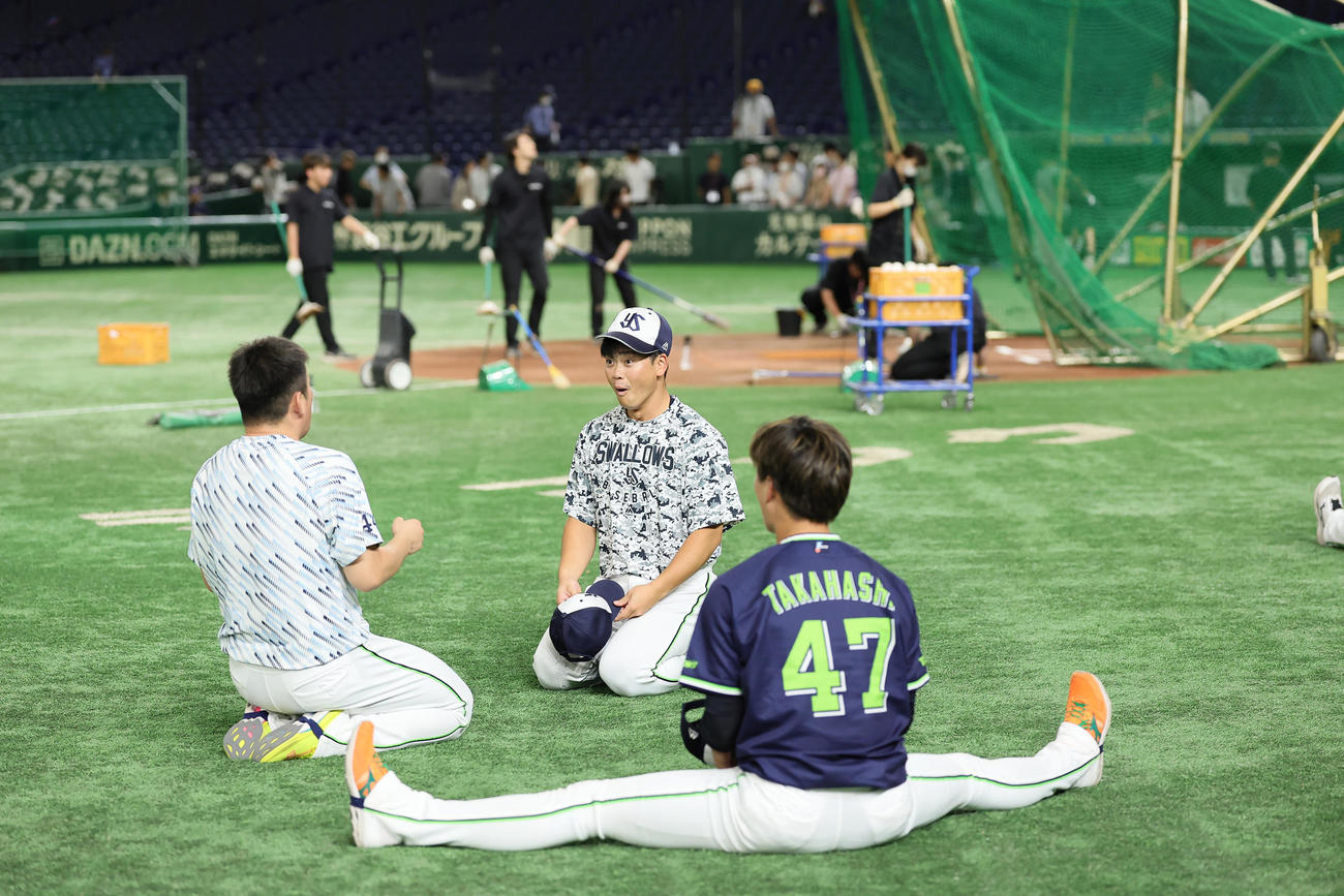 練習中、空中くるりんぱに成功するヤクルトの大西（左）と丸山和（中央）。右は高橋（撮影・足立雅史）