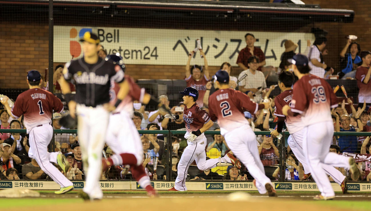 楽天対ソフトバンク　10回裏楽天1死一、二塁、辰己（中央）はサヨナラ左越え適時二塁打を放ち喜ぶファンの中、ナインの水シャワーから逃げるため激走する（撮影・浅見桂子）