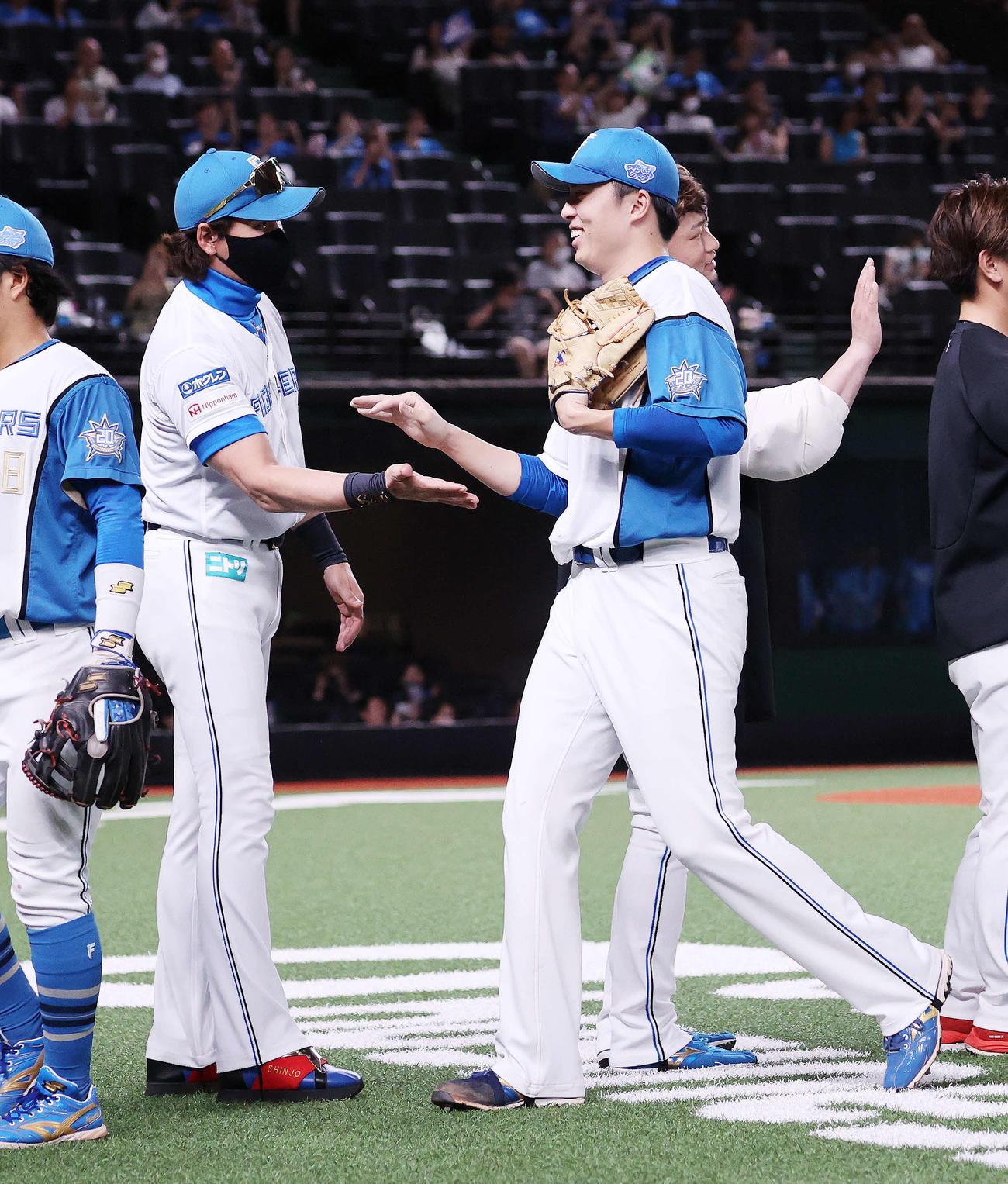西武対日本ハム　勝利しあ日本ハム新庄監督（左）は田中正とタッチ（撮影・鈴木正人）