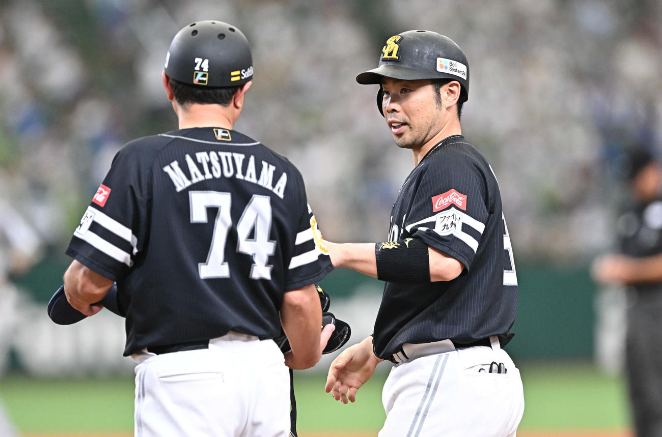西武対ソフトバンク　7回表ソフトバンク2死三塁、近藤（右）は中前適時打を放ち松山コーチとタッチをかわす（撮影・滝沢徹郎）