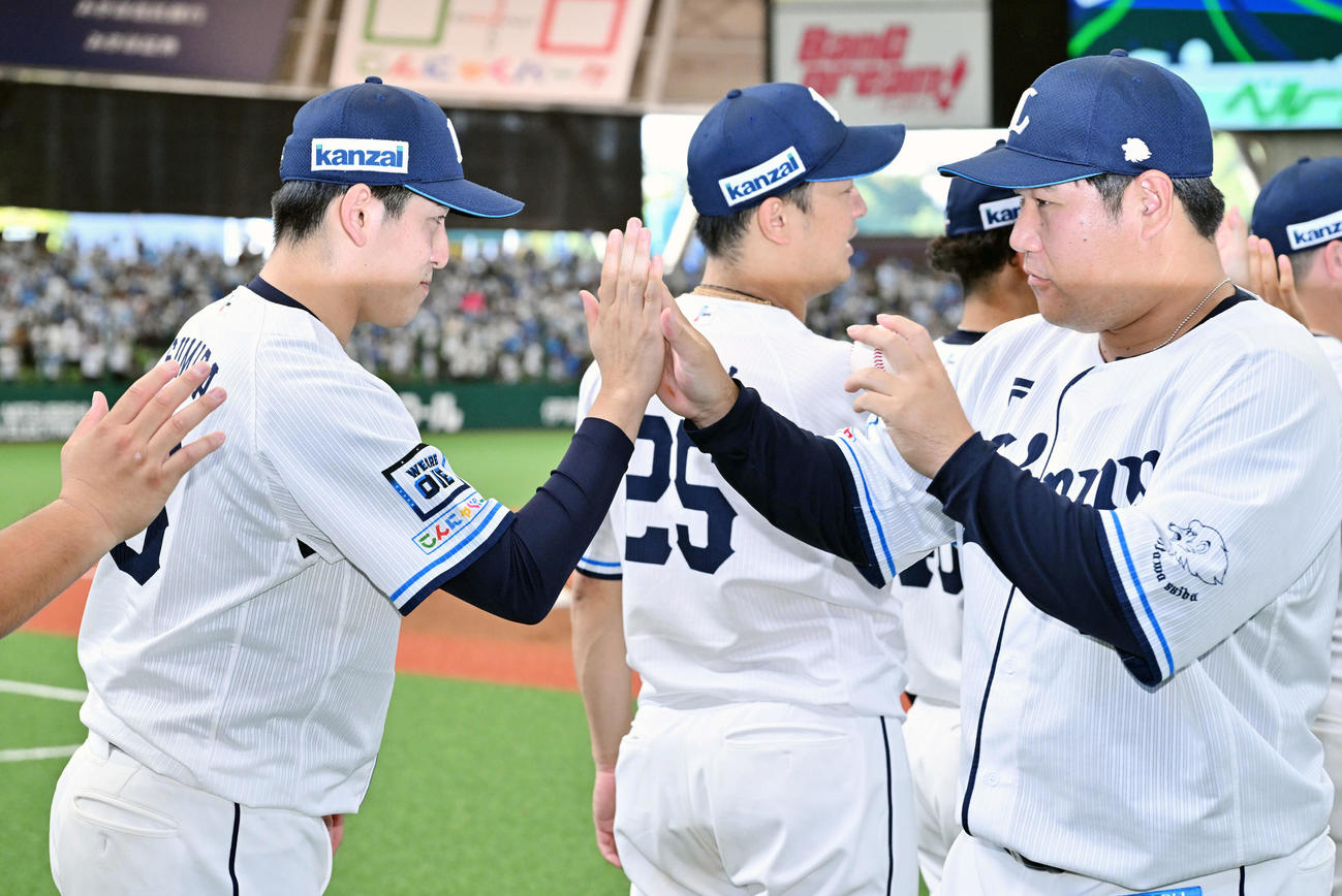 西武対ロッテ　試合後、ウイニングボールを手にする西武中村（右）とタッチをかわす勝利投手の隅田（撮影・滝沢徹郎）