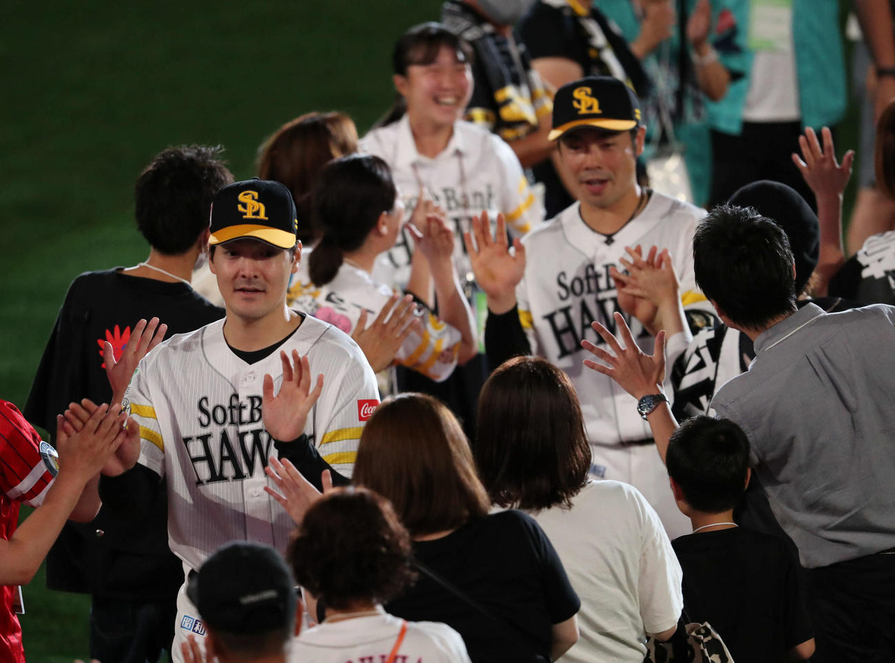 ソフトバンク対ロッテ　ヒーローになった有原（手前）と近藤はファンとハイタッチをかわす（撮影・梅根麻紀）