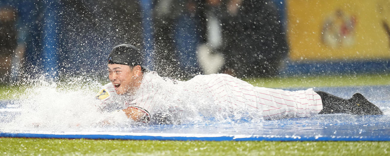 ヤクルト対阪神雨天中止　雨天中止となり、本塁へヘッドスライディングするヤクルト丸山和（撮影・鈴木みどり）