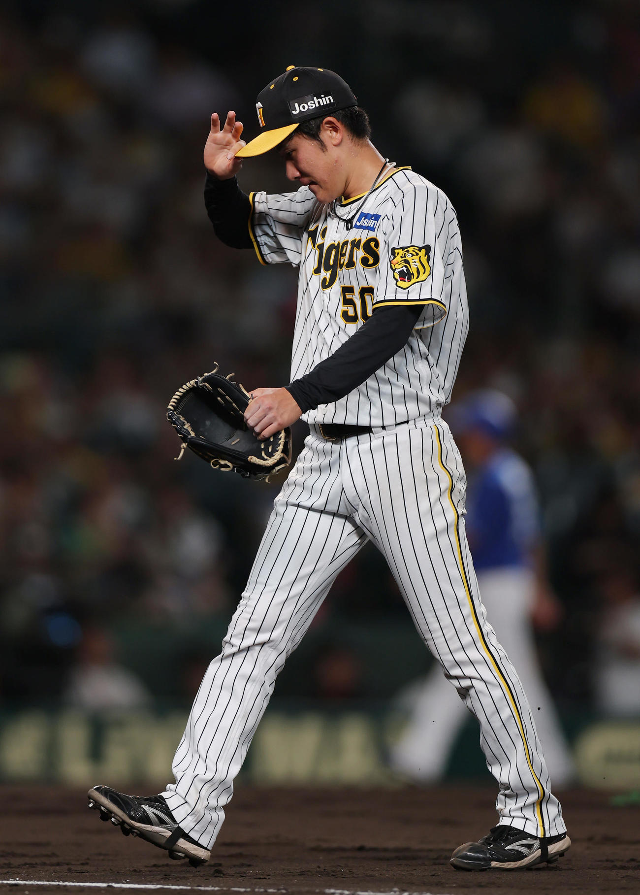 阪神対中日　5回表を投げ終え、うつむきながらベンチへ戻る阪神富田（撮影・前田充）