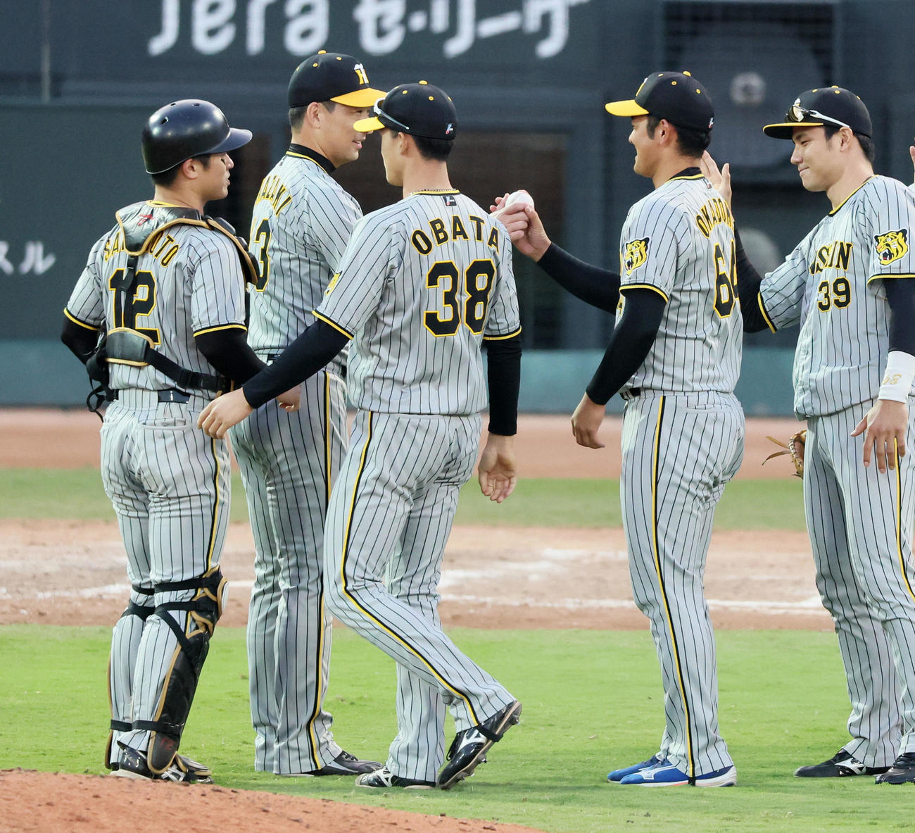 広島対阪神　プロ初勝利を挙げた岡留（右から2人目）は岩崎（左から2人目）から勝利球を受け取る（撮影・加藤哉）