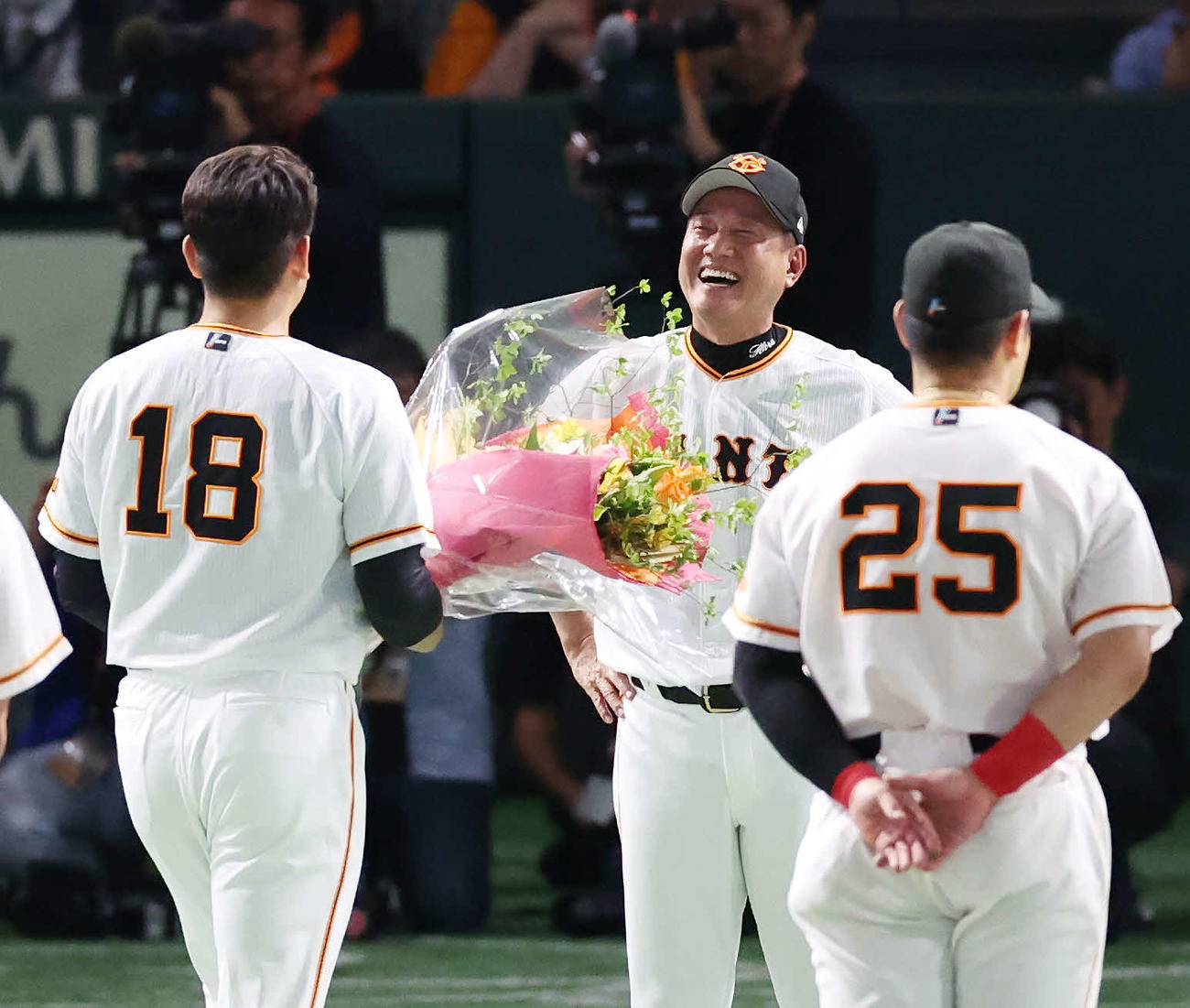 最終戦セレモニーで巨人菅野（左）からの花束に笑顔を見せる原監督（撮影・宮地輝）