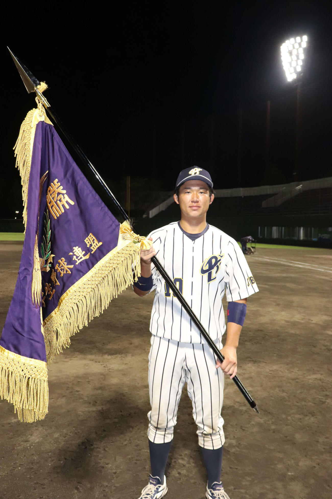 上武大対白鴎大　2季ぶり39回目の優勝を決め、主将として優勝旗を手にした上武大・進藤（撮影・保坂淑子）