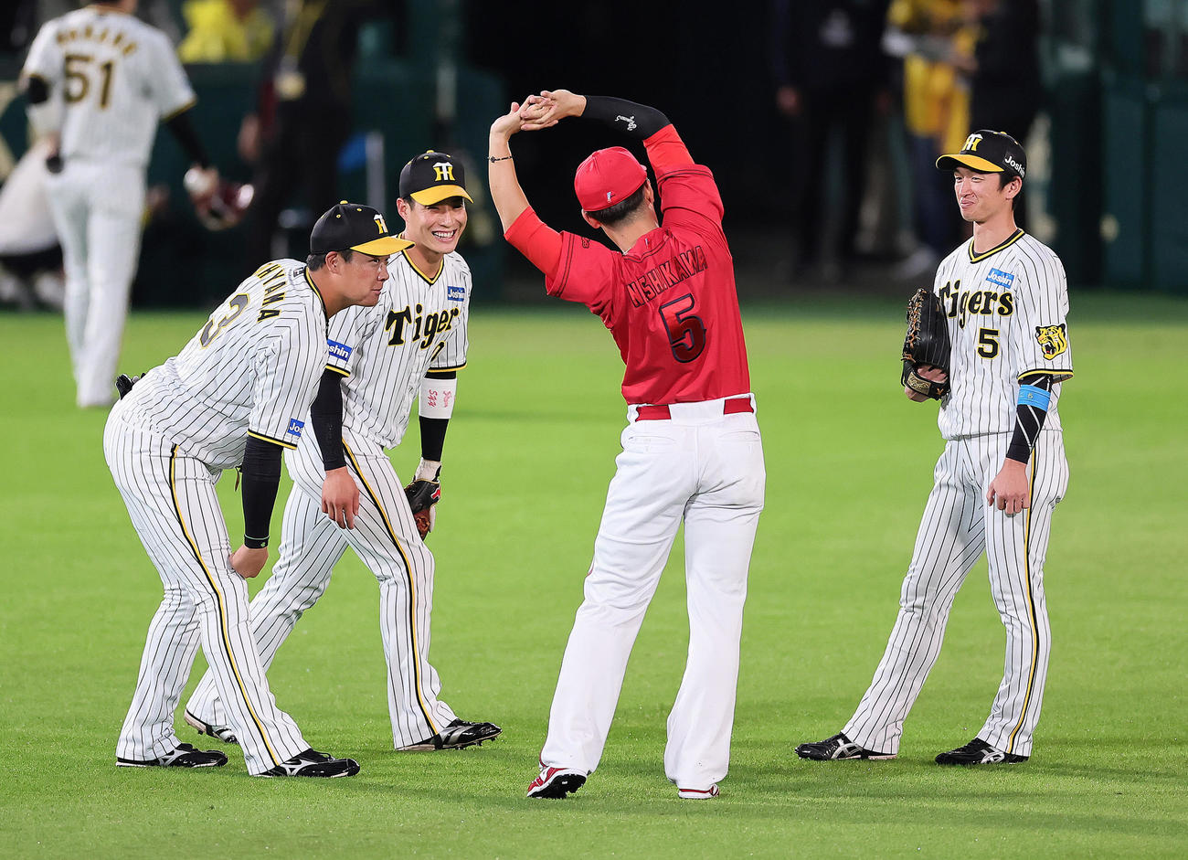 試合前、広島西川（中央右）と談笑する阪神の、左から大山、木浪、1人おいて近本（撮影・足立雅史）