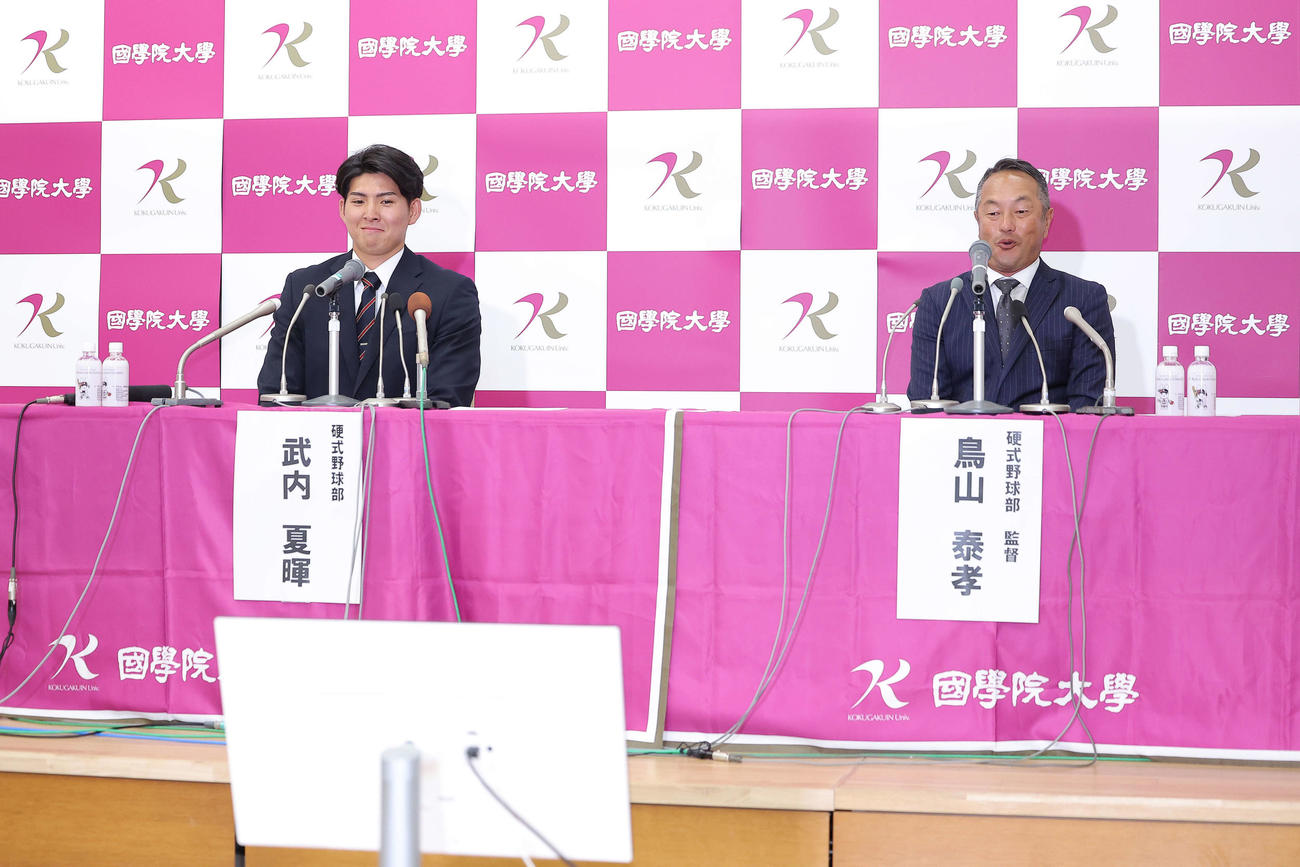 西武1位指名を受け、笑顔を見せる国学院大・武内（左）と鳥山泰孝監督（撮影・河田真司）