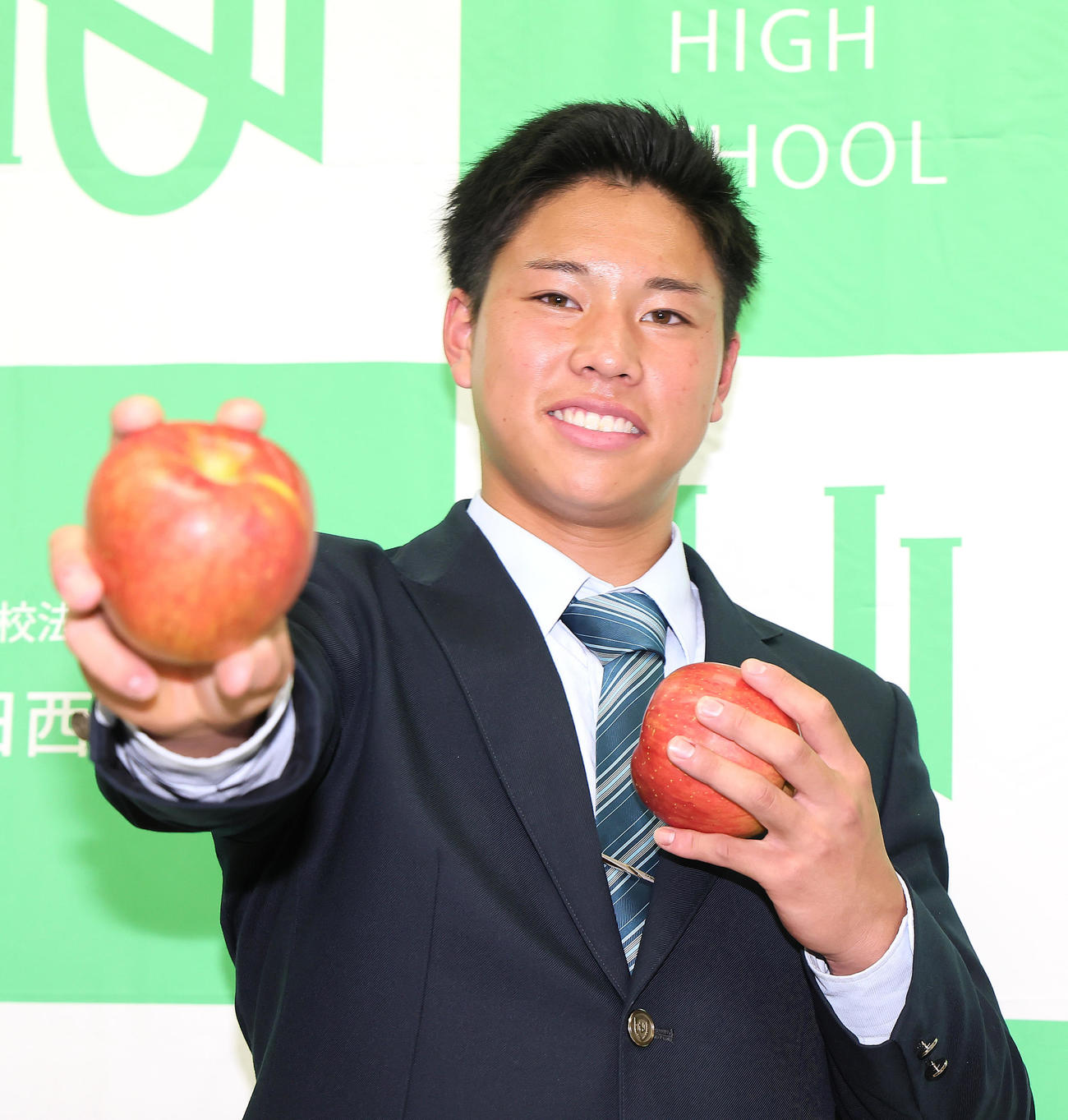 オリックスに1位指名された上田西・横山は信州のリンゴを手にポーズを決める（撮影・足立雅史）