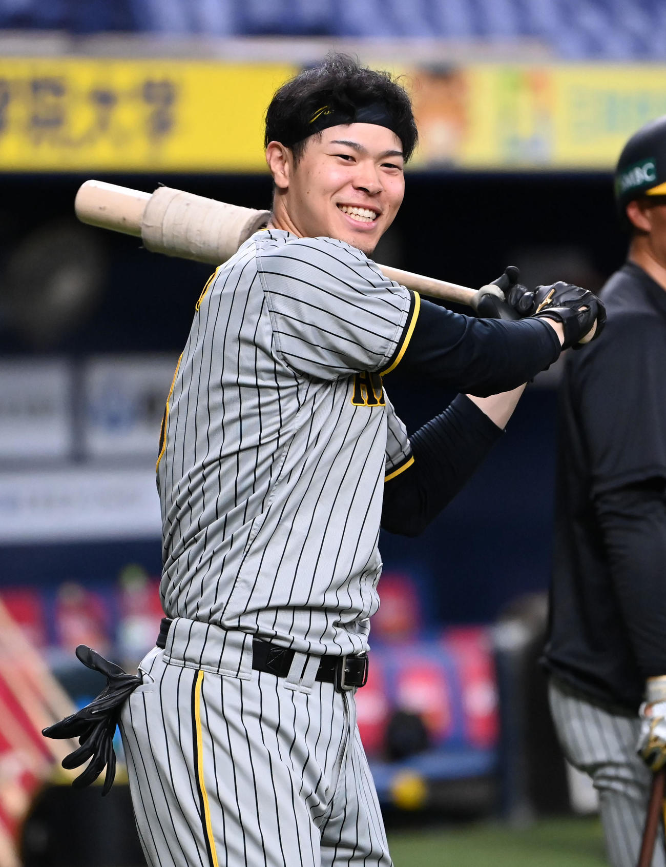 打撃練習の合間に笑顔を見せる佐藤輝（撮影・石井愛子）
