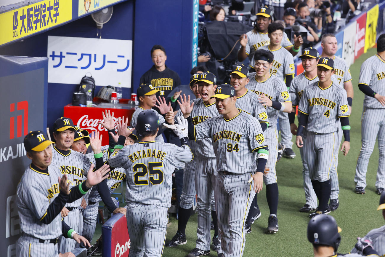 オリックス対阪神　5回表阪神2死一、二塁、近本の2点適時三塁打で生還した渡辺を出迎える阪神ナイン（撮影・藤尾明華）
