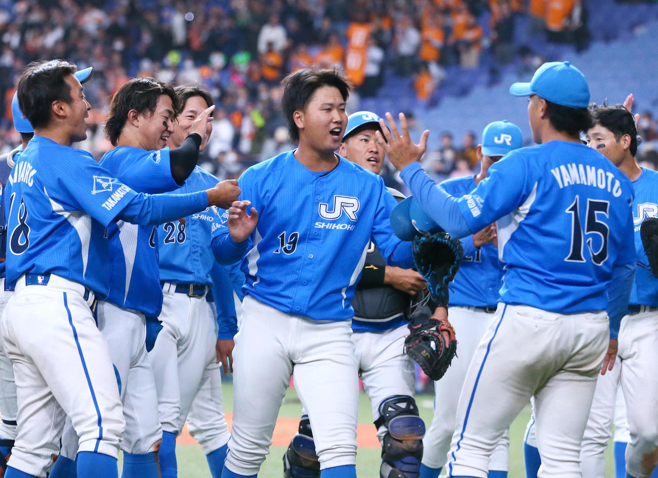 JR四国の近藤（中央）はJR東海から完投勝利し仲間と喜ぶ（撮影・上山淳一）