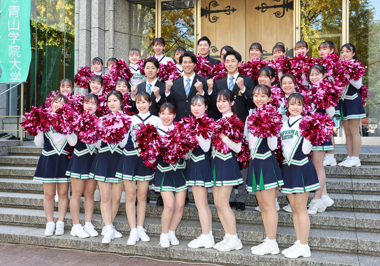 東都大学野球秋季リーグ戦の優勝報告会を行った青学大・下村（左）、中島（中央）、常広はチアリーダーに囲まれ記念撮影する（撮影・宮地輝）