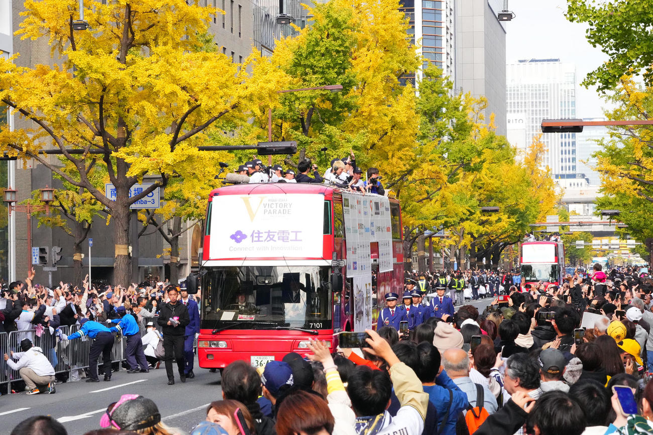 優勝パレードで沿道のファンに手を振るオリックスナイン（撮影・藤尾明華）