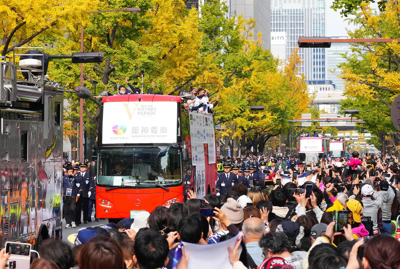 優勝パレードで沿道のファンに手を振るオリックスナイン（撮影・藤尾明華）
