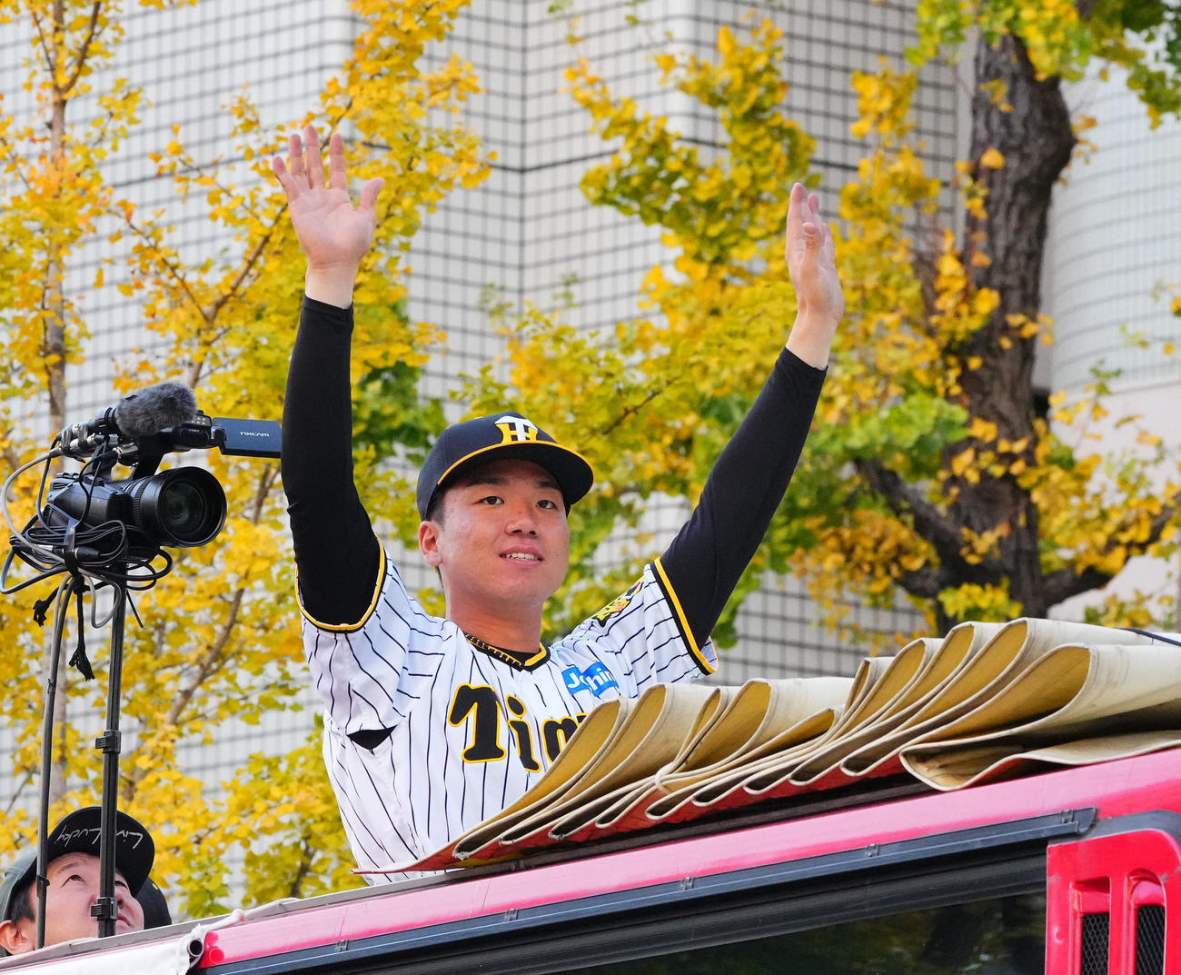 優勝パレードで、沿道のファンに手を振る阪神村上（撮影・藤尾明華）