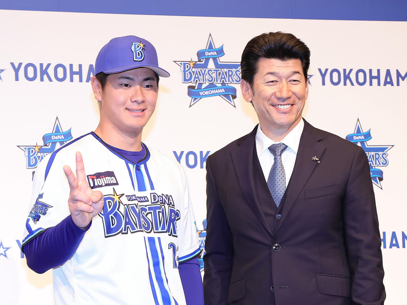 DeNA新入団選手発表会を終えた育成1位の高見沢（左）は三浦監督との記念撮影に笑顔でピース（撮影・足立雅史）