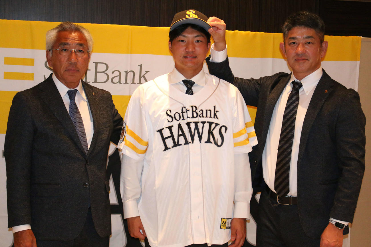 都内のホテルでソフトバンクと仮契約を結んだドラフト4位の明大・村田賢一投手（左は宮田善久スカウト、右は福山龍太郎アマスカウトチーフ）（撮影・木下大輔）