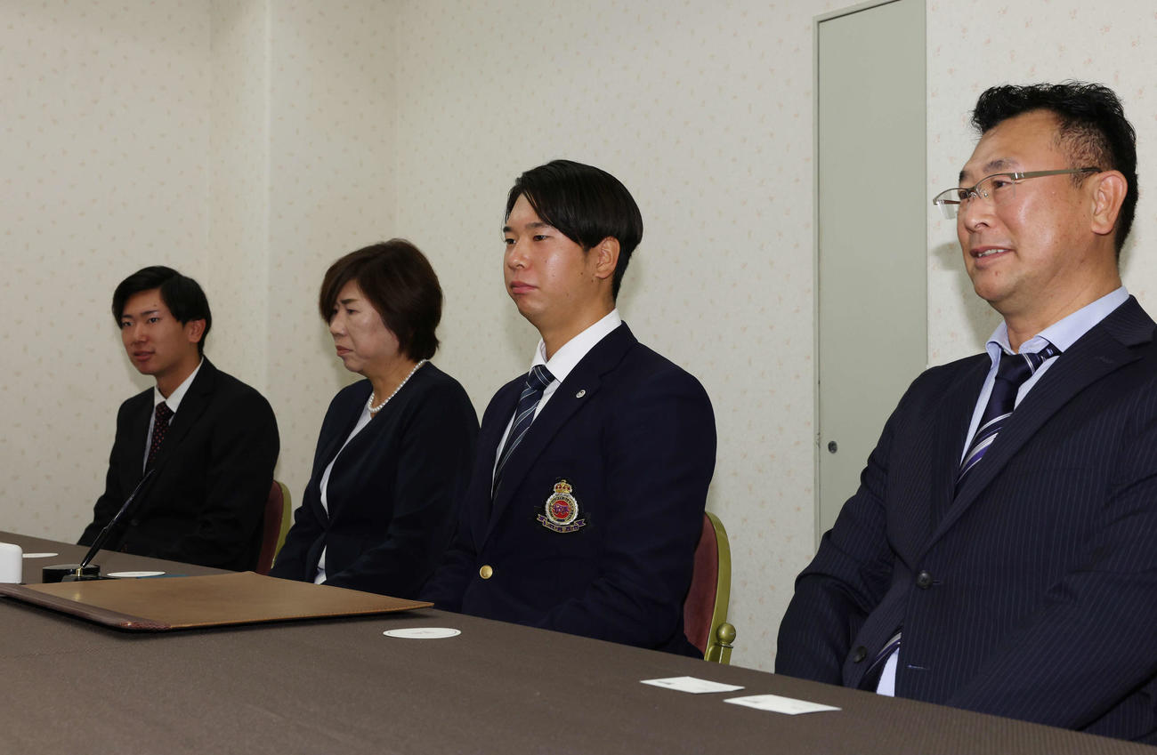 契約に臨むロッテドラフト1位の明大・上田（左から3人目）と家族、左から弟の琉久、母の恭代さん、1人おいて父の宏典さん（撮影・宮地輝）