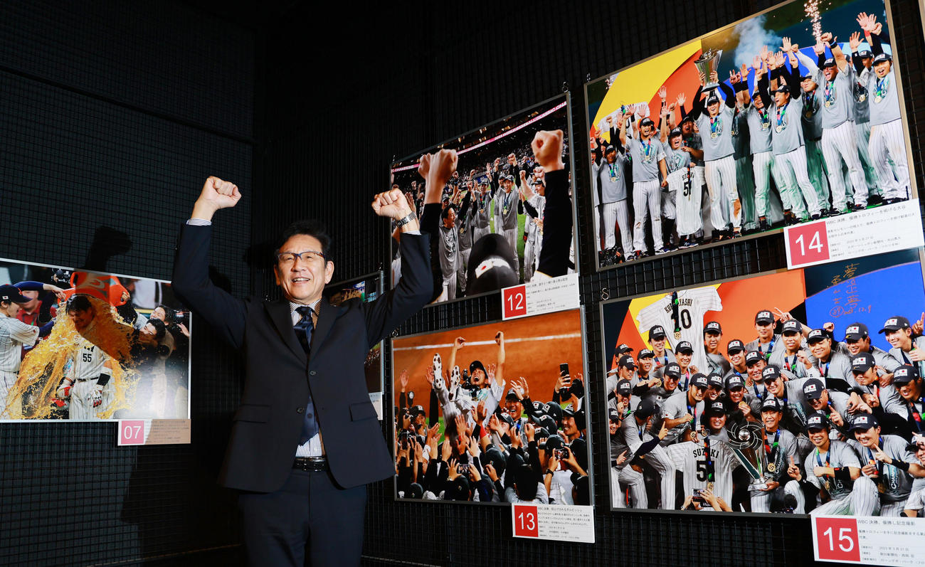 野球殿堂博物館で始まった「野球報道写真展」を訪れ、WBCでの自らの写真の前で万歳する侍ジャパン前監督の栗山氏（撮影・野上伸悟）
