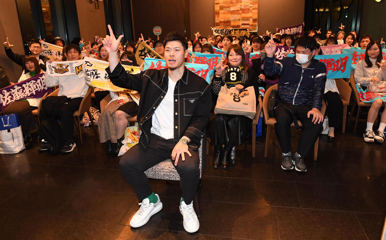 ファンとの記念撮影で「バモス」ポーズを決める佐藤輝（撮影・前岡正明）