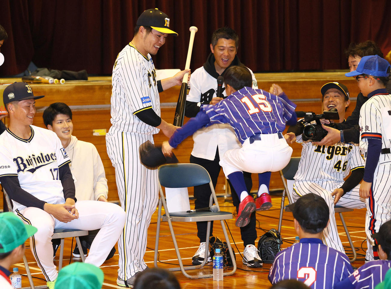 奈良県人会の野球教室の抽選会で阪神小野寺（左から3人目）のバットが当選し大喜びする子供。左はオリックス曽谷、右は阪神島本（撮影・上山淳一）