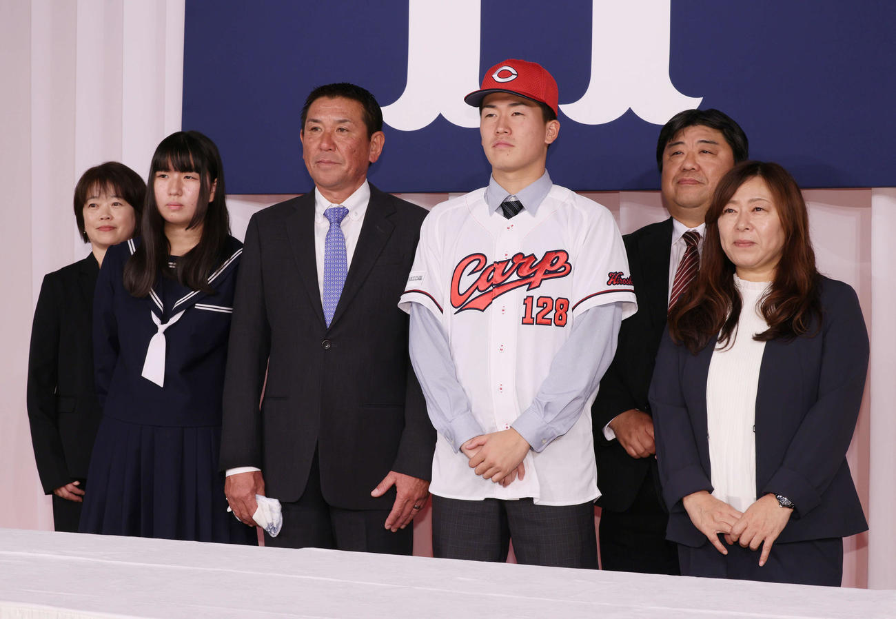 広島新入団選手会見　家族と写真におさまる育成3位の杉原望来（左から4人目）。左から母の静代さん、妹の寿望さん、父の博樹さん、育成3位の杉原、叔父の小田善憲さん、叔母の小田香里さん（撮影・加藤孝規）