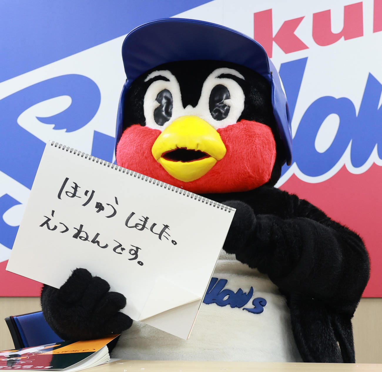 契約更改交渉を終え、フリップに「ほりゅうしました。えつねんです」と書くつば九郎（撮影・野上伸悟）