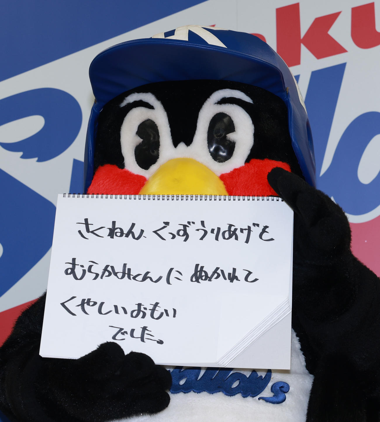 契約更改交渉を終え、フリップに「さくねん、ぐっずうりあげをむらかみくんにぬかれてくやしいおもいでした」と書くむつば九郎（撮影・野上伸悟）