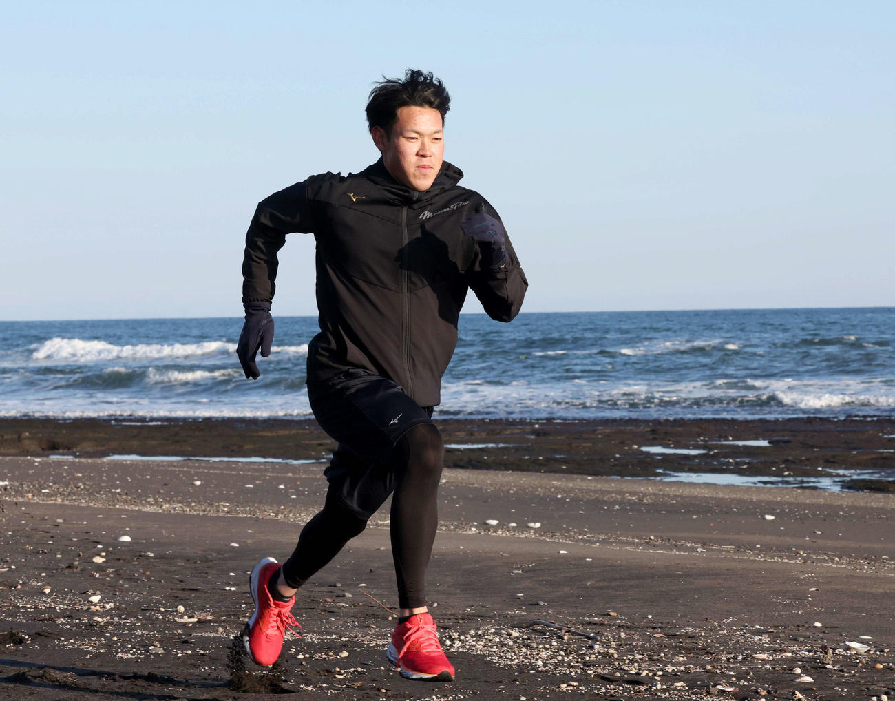 砂浜でダッシュする日本ハム根本（撮影・黒川智章）