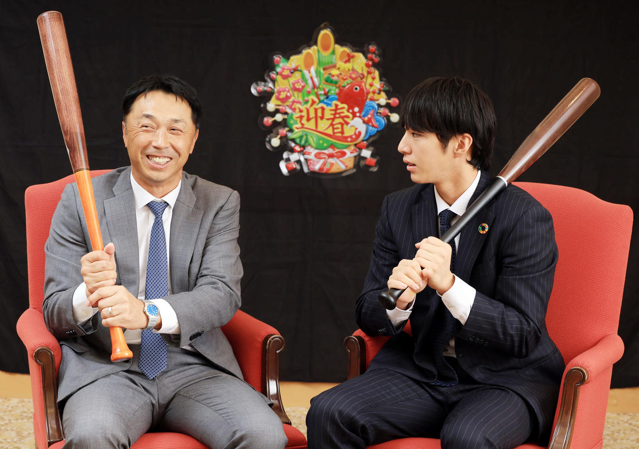 バットを手に、宮本慎也氏（左）から打撃について熱心にアドバイスを受けるDeNA度会（撮影・浅見桂子）