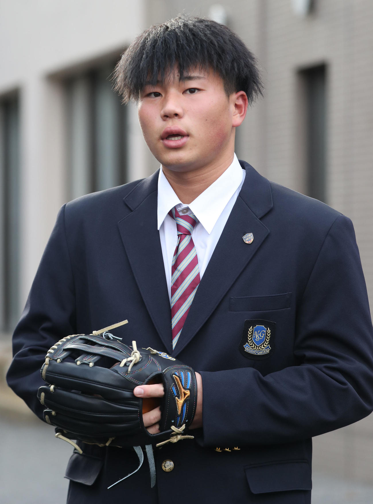 入寮しグラブを手に囲み取材に応じる日本ハムドラフト4位明瀬（撮影・佐藤翔太）