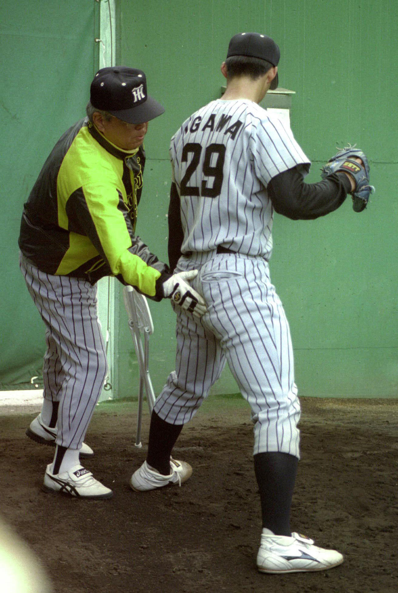 1999年阪神春季キャンプ　井川慶（右）に手取り足取り、熱心に指導する野村克也監督