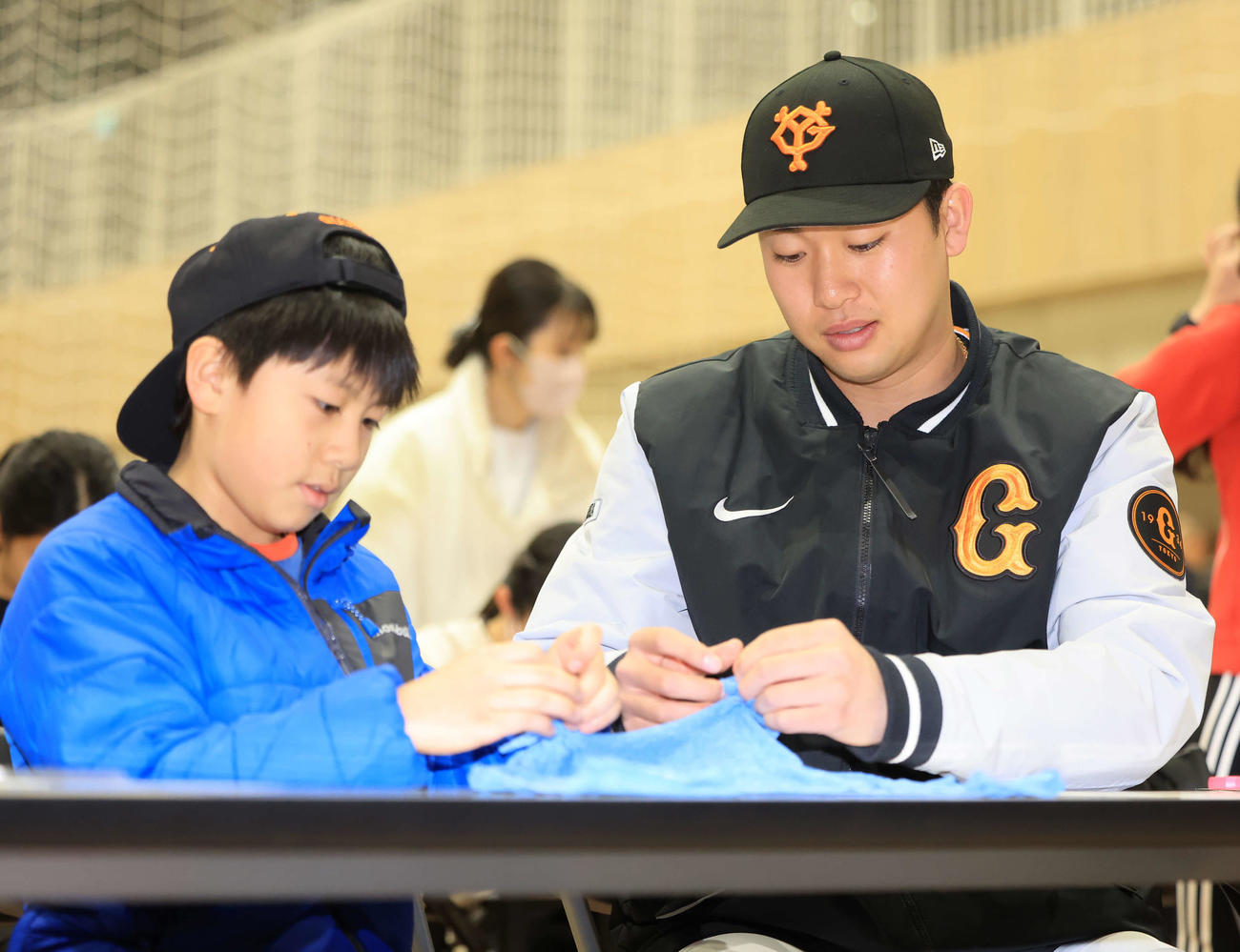 脱炭素アクションを学ぶ体験型イベントで、子どもたちと一緒に、エコバックを作る巨人山崎伊（撮影・浅見桂子）