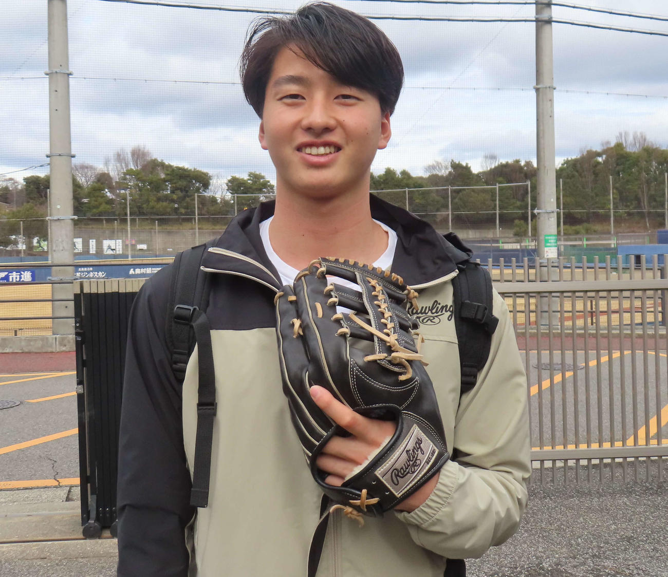 鎌ケ谷の自主トレでグラブを片手に笑顔を見せる日本ハム・藤田（撮影・佐瀬百合子）